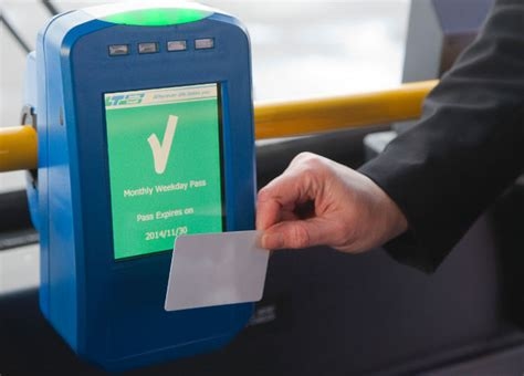 A person scanning a bus pass